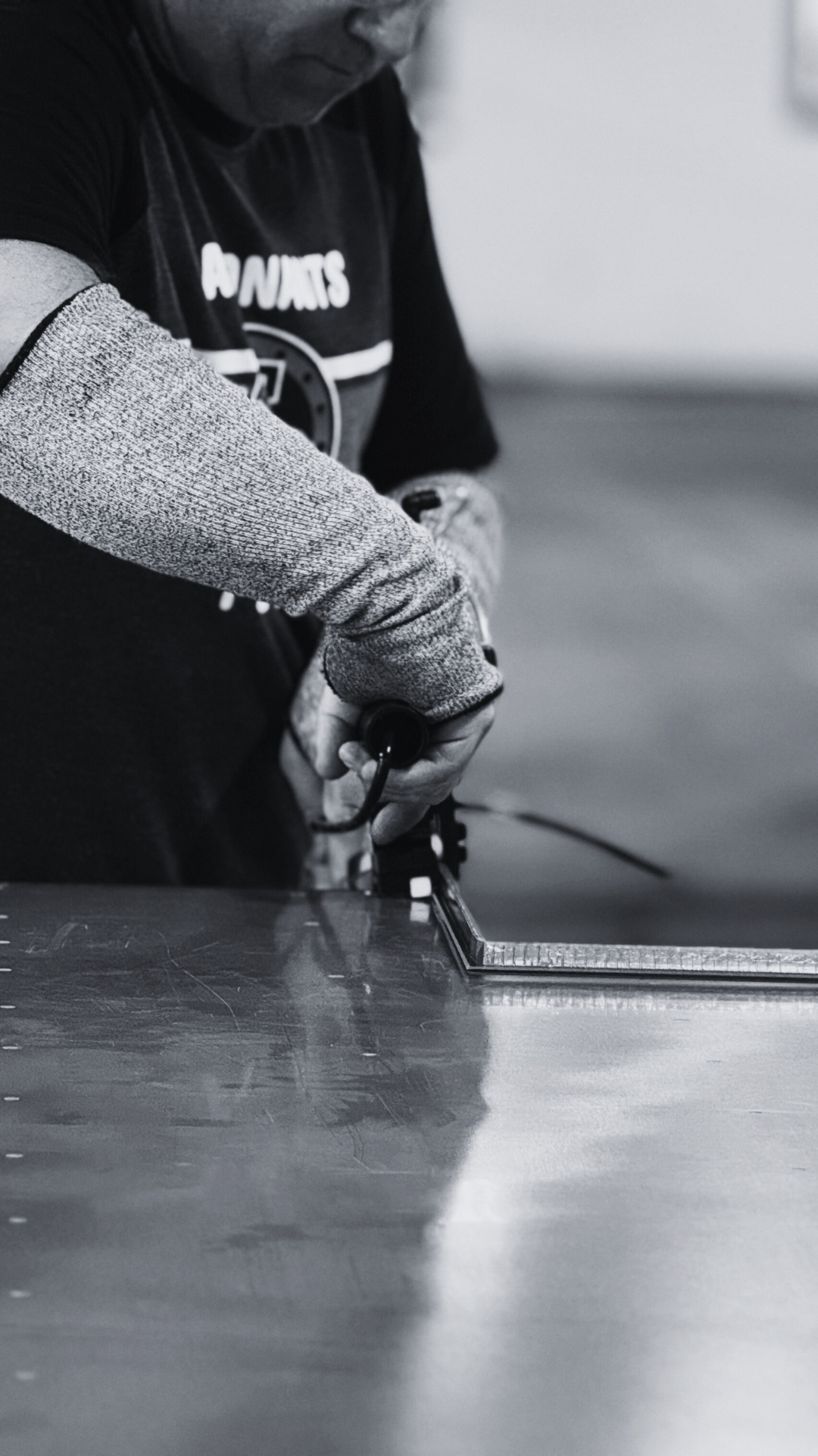 Technician inspecting spacer alignment during IG assembly